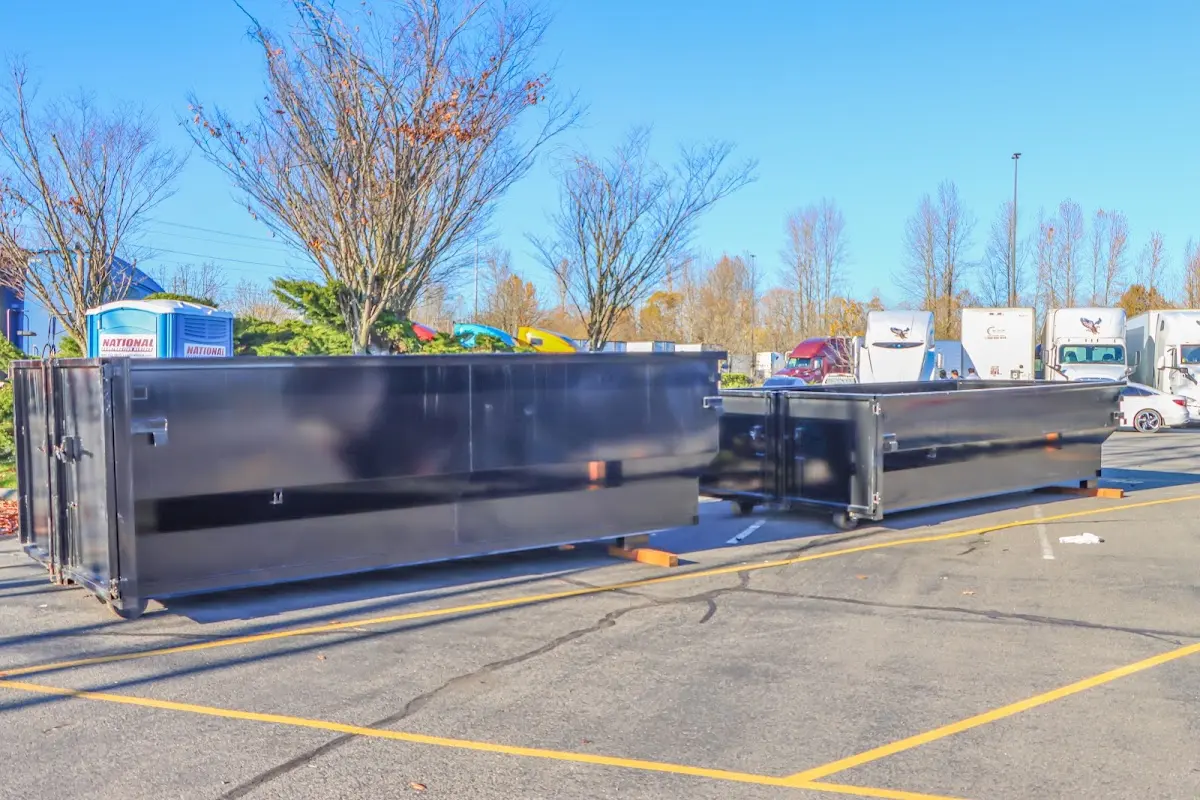 Professional dumpster rental service with roll-off container on residential driveway in Northumberland